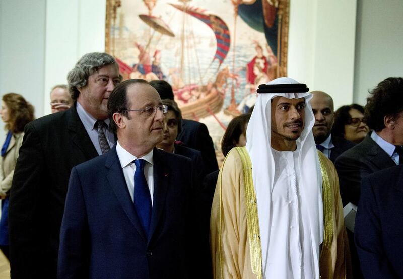 Sheikh Sultan bin Tahnoon, chairman of the Tourism and Cultural Authority Abu Dhabi, and the French president Francois Hollande at the launch of the Birth of a Museum exhibition at the Louvre in Paris. Alain Jocard / AFP