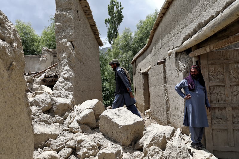 Afghan men assess the damage to a house destroyed by an earthquake in Gayan village, in Paktika province, Afghanistan. Reuters