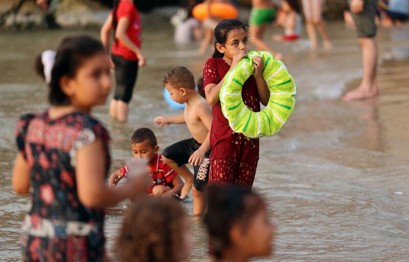 Palestinians enjoy the beach in Gaza City.