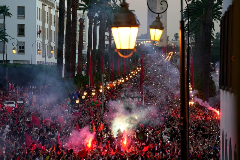 Fans light flares during the Morocco team's homecoming parade in central Rabat. AP 