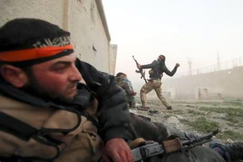 A Free Syrian Army fighter throws a grenade inside a Syrian Army base during heavy fighting in Damascus. Many Syrians are now calling themselves ‘timsahna’, a term derived for the Arabic word for crocodile, and meaning that they are thick-skinned.