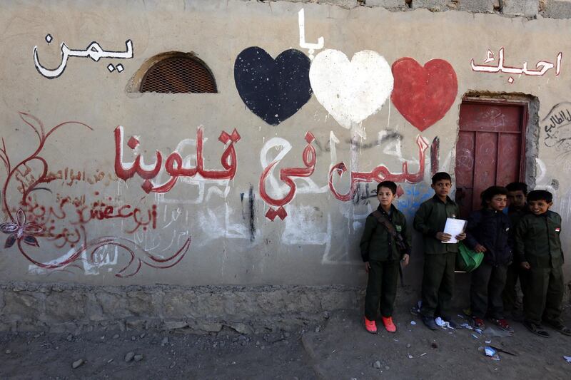 epa06421317 Yemeni students stand beside a sign on a wall reading in Arabic 'Yemen is in our hearts. I love you Yemen' during morning assembly at al-Sadaiq primary school, in Sana'a, Yemen, 03 January 2018 (Issued 06 January 2018). Despite the ongoing conflict, approximately 90 percent of schools in Yemen are still functioning and trying to serve over 4.5 million students. The schools are operational only for two hours a day as a result of the strike by approximately 300 thousand teachers and other education staff, who demand their salaries, which remain unpaid for more than a year, forcing Houthi-held authorities to bring unqualified volunteers to teach students.  EPA/YAHYA ARHAB