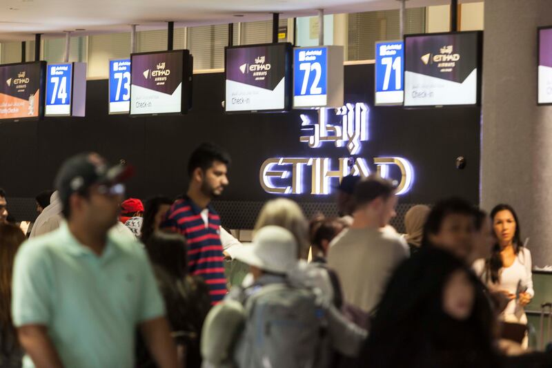 People checking in for flights at Abu Dhbai International Airport, which recorded a 218 per cent jump in passenger numbers in the first quarter of this year. Antonie Robertson / The National