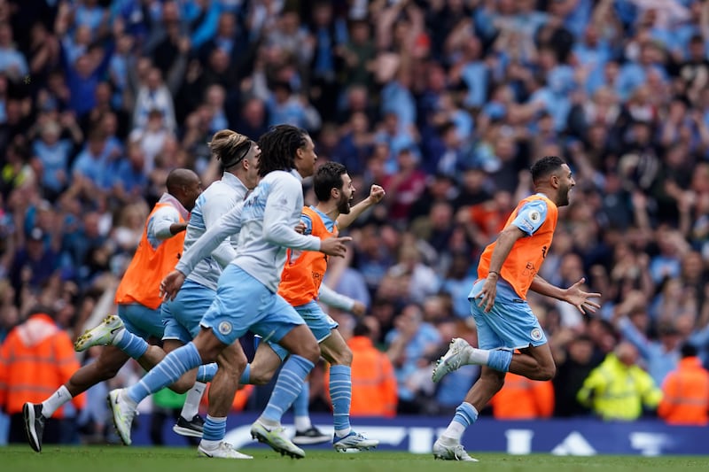 Manchester City players celebrate after winning the Premier League. AP