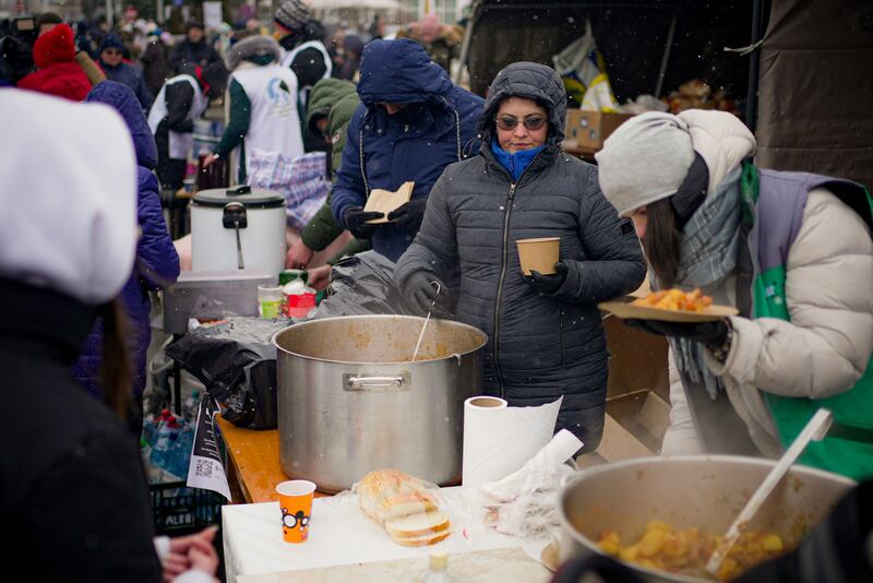 Volunteers at the Romanian border serve hot food to refugees fleeing the conflict from neighbouring Ukraine. AP