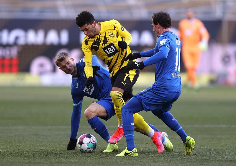 Jadon Sancho of Borussia Dortmund is challenged by Stefan Posch and Sebastian Rudy of Hoffenheim. EPA