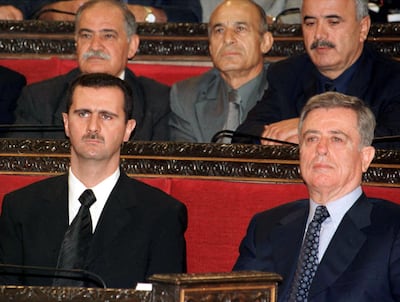 FILE PHOTO: Syrian President Bashar al-Assad  (L) and former Vice President Abdul-Halim Khaddam take part in a session of parliament in this file picture dated July 17, 2000. Khaddam, who later became a prominent opponent of Assad, died on Tuesday./File Photo