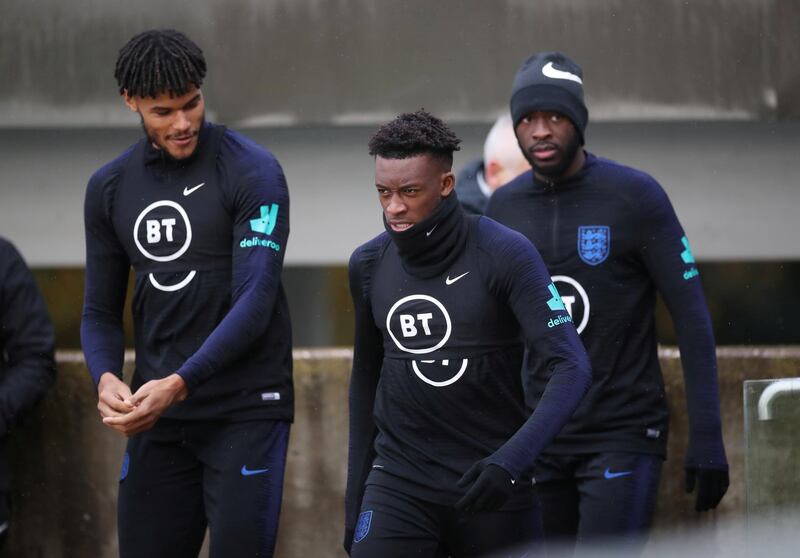 Callum Hudson-Odoi and Tyrone Mings make their way onto the training pitch. Reuters