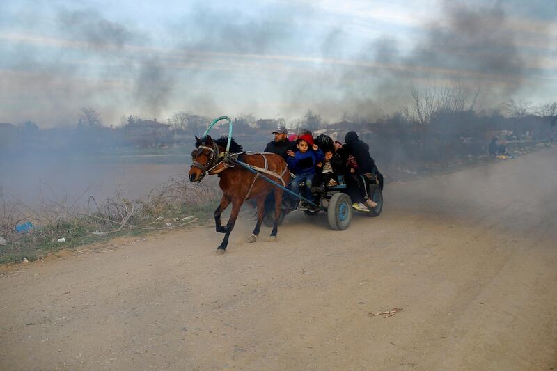 Migrants travel on a horse carriage near the Turkey's Pazarkule border crossing in Edirne, Turkey. Reuters
