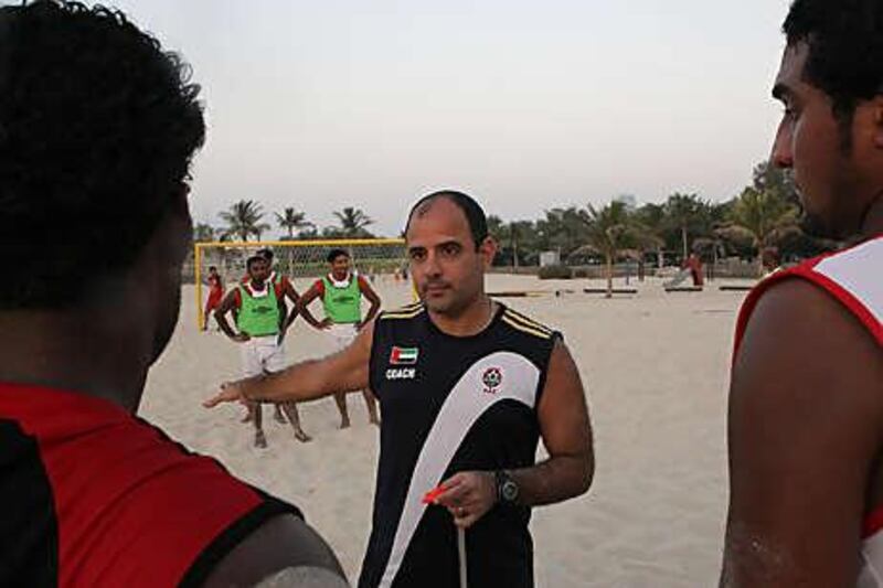 Marcelo Mendes, the UAE beach soccer coach, gives instructions at a team practice.