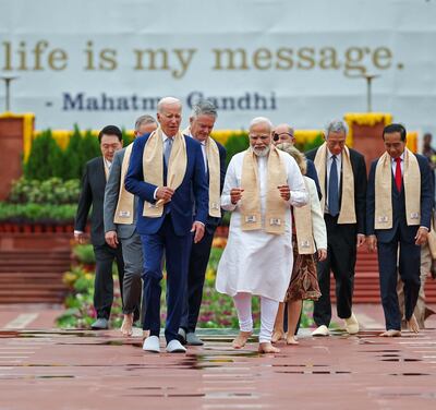 Indian Prime Minister Narendra Modi and US President Joe Biden arrive with other world leaders to pay their respects at the Mahatma Gandhi memorial in New Delhi on Sunday. AFP