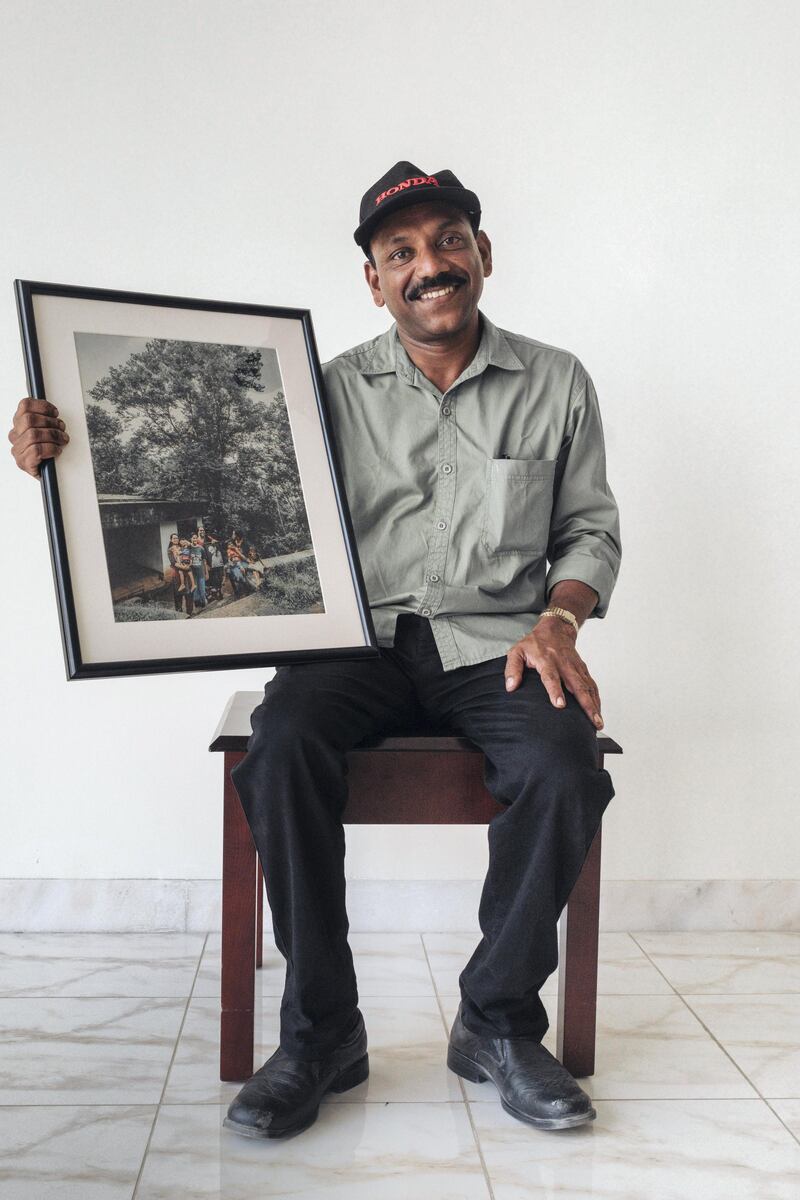 Joy receives the picture of his family with the portrait of him. Courtesy Waleed Shah and Nikith Nath
