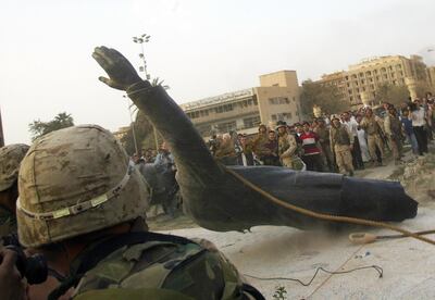 (FILES) In this file photo taken on April 9, 2003, a statue of Saddam Hussein falls as it is pulled down by a US armoured vehicle in Baghdad's al-Fardous square.
On April 9, 2003, the US-led coalition overthrew Saddam Hussein. Fifteen years after the invasion, life in Iraq has been transformed as sectarian clashes and jihadist attacks have divided families and killed tens of thousands of people, leaving behind wounds that have yet to heal and a lagging economy. / AFP PHOTO / RAMZI HAIDAR