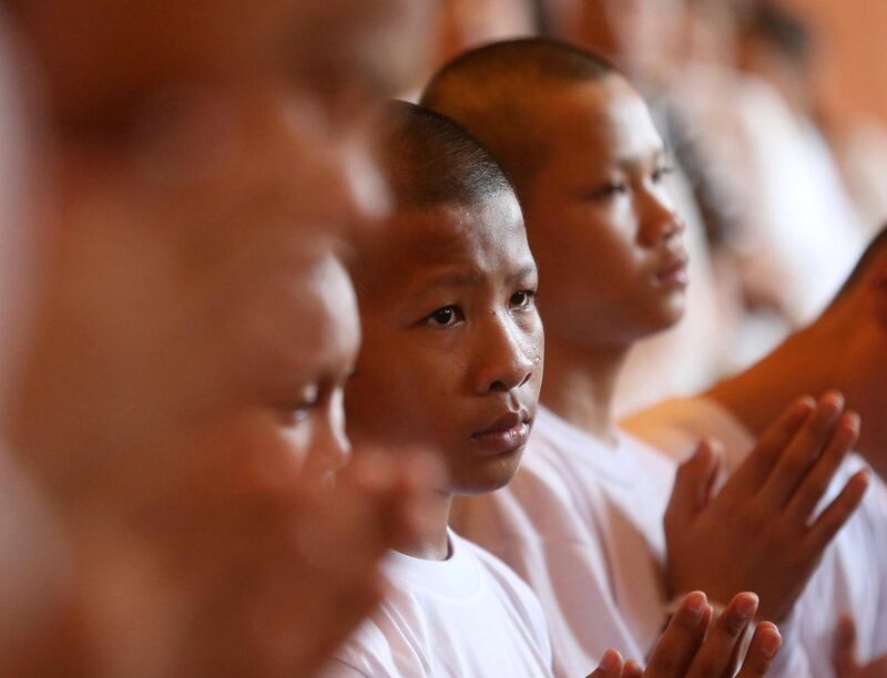 Members of Wild Boars soccer team listen to a monk pray after the ceremony. AP Photo