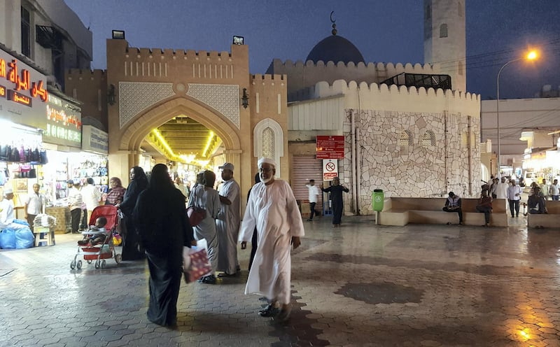 MUTRAH SOUK, MUSCAT, OMAN - 2016/07/19: Local men and women cross paths at an entrance to Mutrah souk. (Photo by Dominic Dudley/Pacific Press/LightRocket via Getty Images)