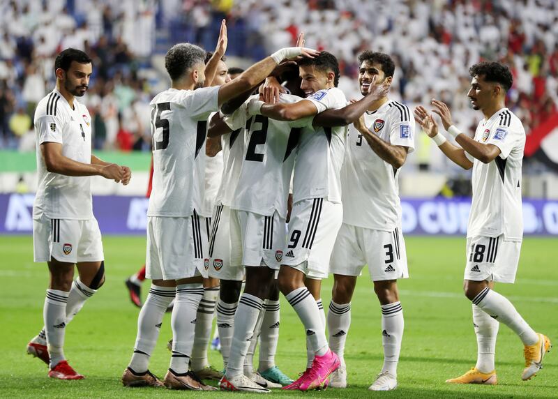 Khalifa Al Hammadi of the UAE celebrates scoring with teammates.