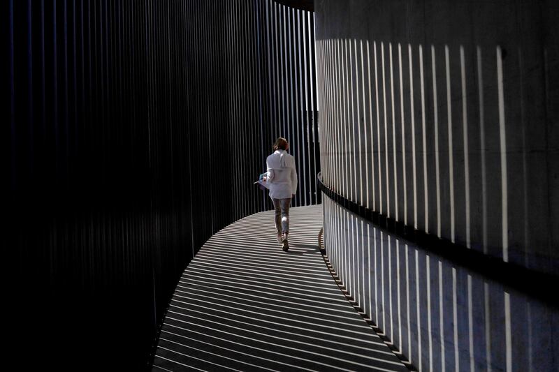 A woman walks up the spiral stairs at the Circa Gallery as part of the Keyes Art Mile in Johannesburg, South Africa.  EPA