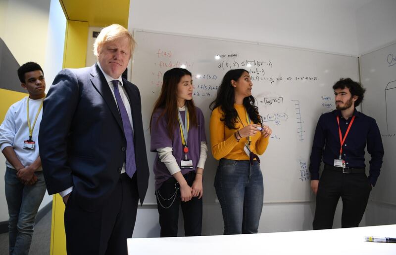 Britain's Prime Minister Boris Johnson reacts as he listens to students solving maths questions during his visit to the Department of Mathematics at King's Maths School, part of King's College London University, in central London on January 27, 2020. Britain on Sunday announced a new fast-track visa scheme for top scientists, researchers and mathematicians as it prepares a new immigration system for life outside the European Union. Prime Minister Boris Johnson revealed the plan just days before Brexit finally takes place on January 31. / AFP / POOL / DANIEL LEAL-OLIVAS
