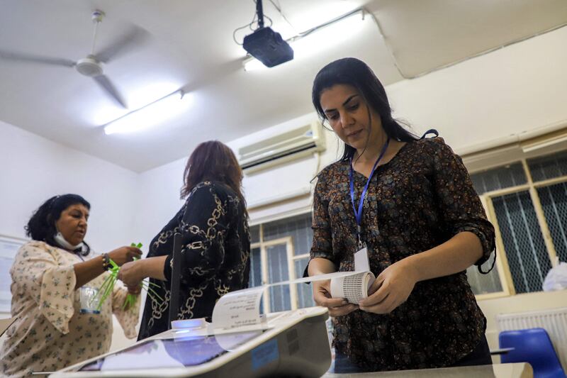 Iraqi officials print out the electronic count of votes at a polling station in the north-eastern city of Sulaymaniyah. AFP