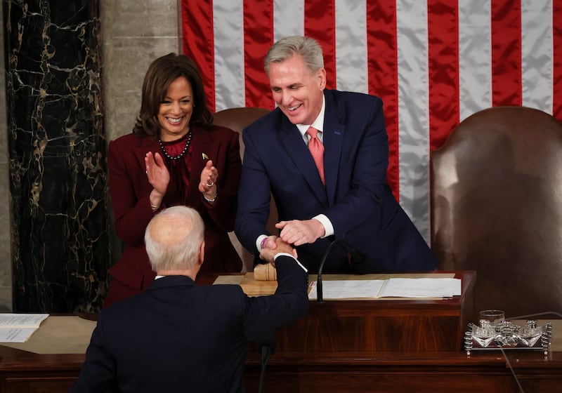 US Vice President Kamala Harris and Speaker of the House Kevin McCarthy greet Mr Biden as he arrives to deliver his State of the Union address. Reuters