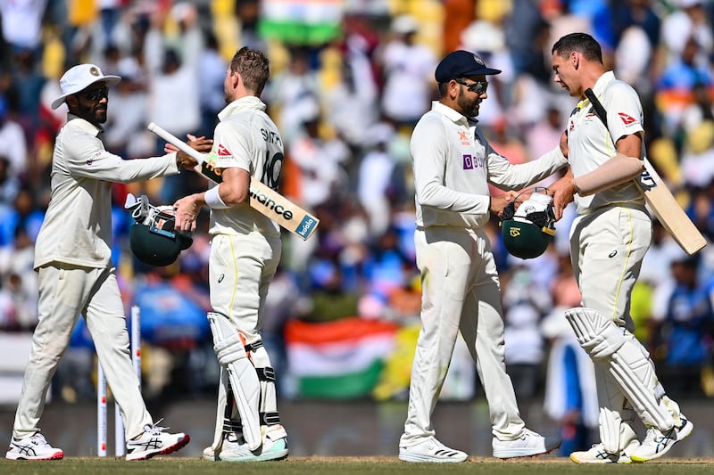 India's players shake hands with the Aussies after the conclusion of the first Test. AFP