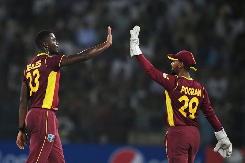 West Indies' Jayden Seales celebrates with captain Nicholas Pooran after taking the wicket of Pakistan's Fakhar Zaman in Multan. AFP