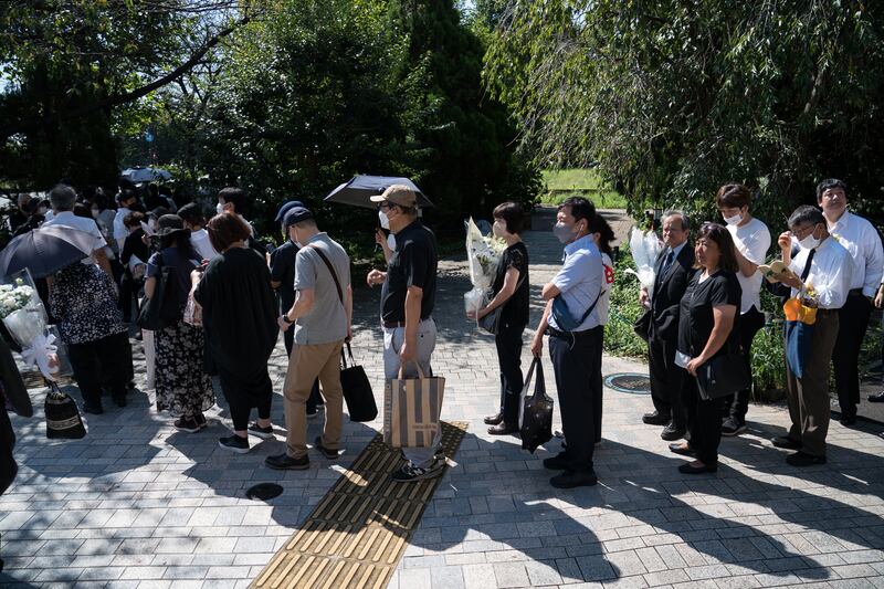 The queue to leave flowers at a park near the Nippon Budokan, where Abe's funeral was held. Getty