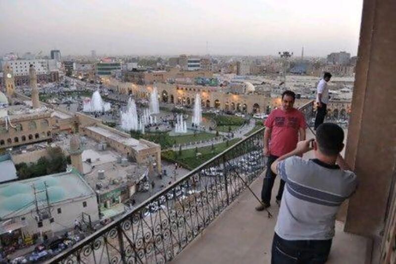Tourists take photographs at Erbil's Citadel. Rosemary Behan / The National