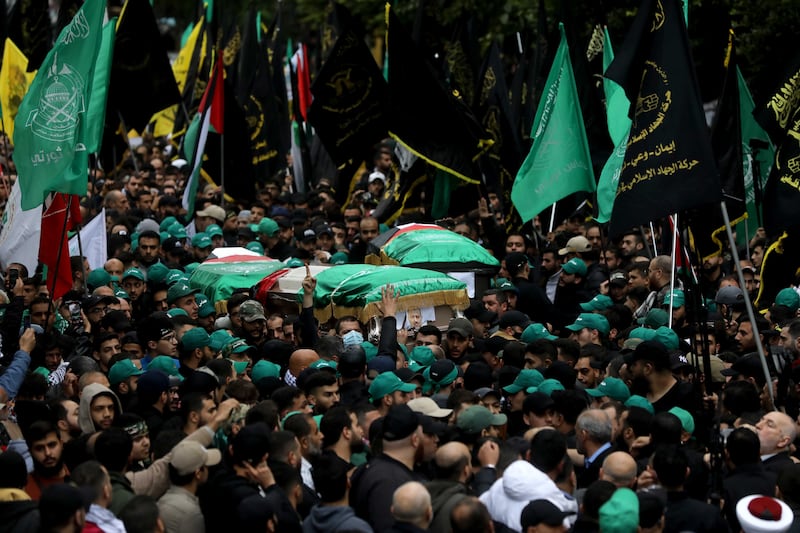 The coffin of Mr Al Arouri is carried through the streets. Getty Images