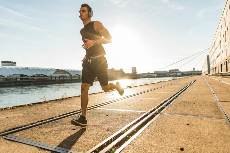 Young athlete jogging in the city at the river. Getty Images