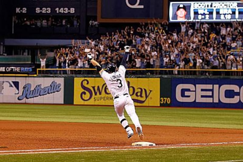 Evan Longoria celebrates rounding the bases at the bottom of the 12th inning after his home run helped Tampa Bay Rays come from 7-0 down to beat the New York Yankees and seal their place in the play-offs.