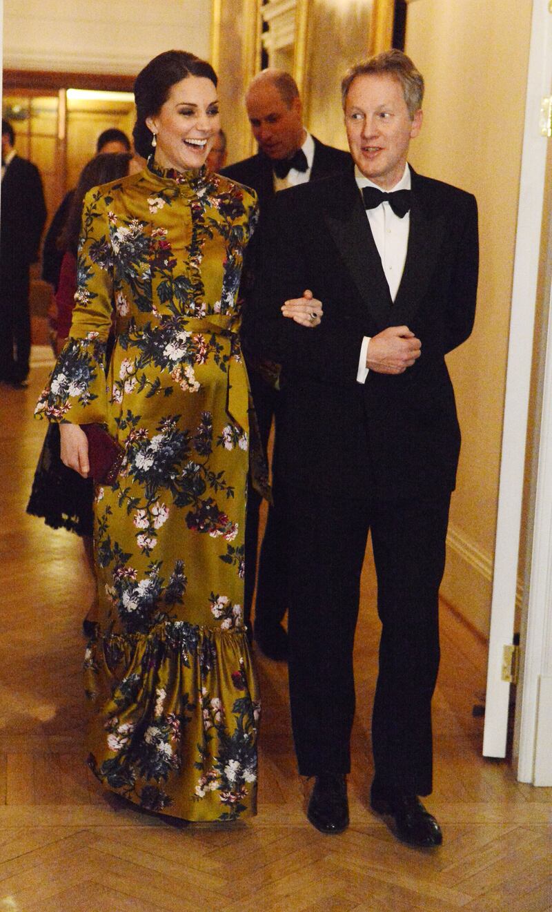 Catherine, Duchess of Cambridge, in gold and green Erdem, with British ambassador to Sweden David Cairns during a visit to Sweden on January 30, 2018. Getty Images