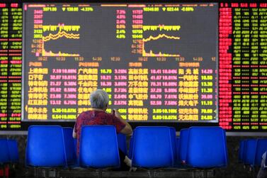 An investor looks at an electronic board showing stock information in Shanghai. In February, when Wuhan became the centre of the coronavirus pandemic, few would have bet on China being the best-performing major global stock market of 2021. Reuters