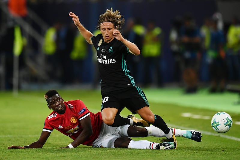 Manchester United's Paul Pogba tackles Real Madrid's Luka Modric. Dan Mullan / Getty Images