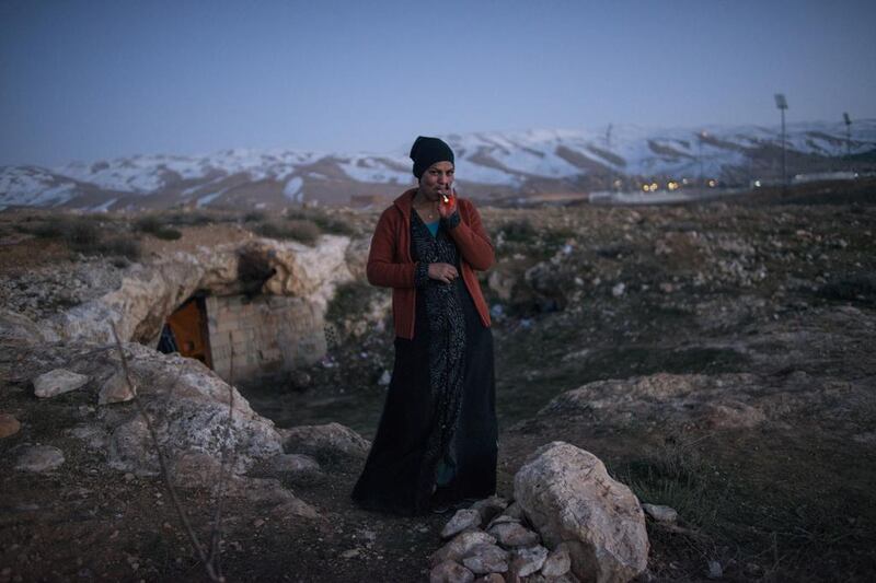 Dalal, 21, a refugee from Damascus, in front of the cave in Lebanon she and her family were staying in, 2013. Courtesy Lynsey Addario