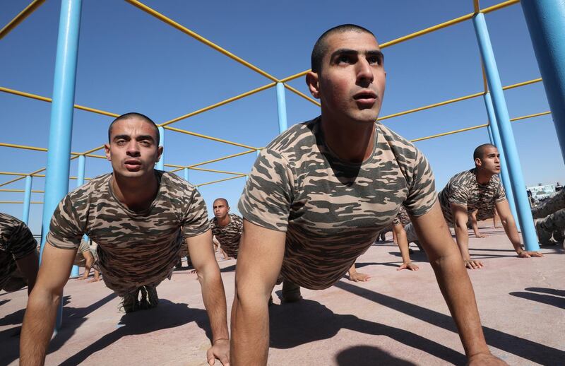 Egyptian police cadets perform push-ups.