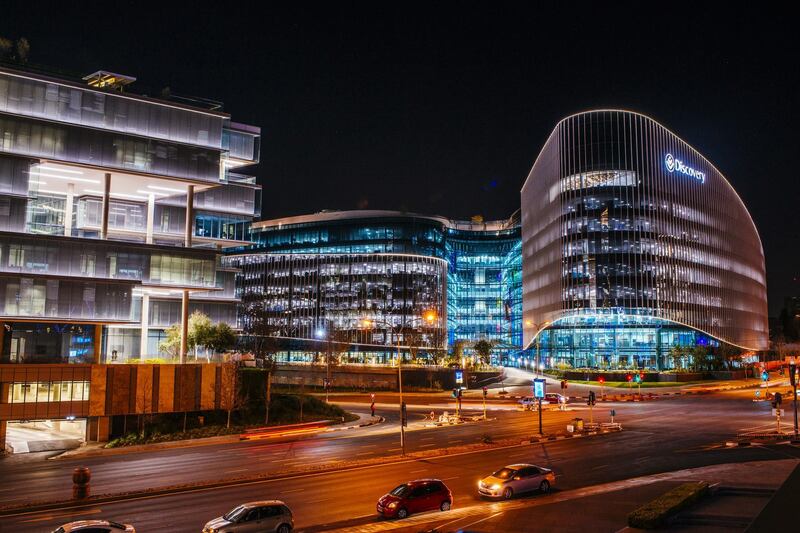 Lights illuminate the windows of the Discovery Ltd. headquarters office in the Sandton district of Johannesburg, South Africa, on Tuesday, July 17, 2018. South Africa's cash-strapped power utility, Eskom Holdings SOC Ltd., is "a threat" to the nation's investment strategy, Finance Minister Nhlanhla Nene said. Photographer: Waldo Swiegers/Bloomberg