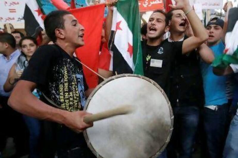 Lebanese shout slogans against Syrian President Bashar Al Assad during a protest against Syria's ambassador to Lebanon and against the Syrian regime's mass killings, in Beirut.