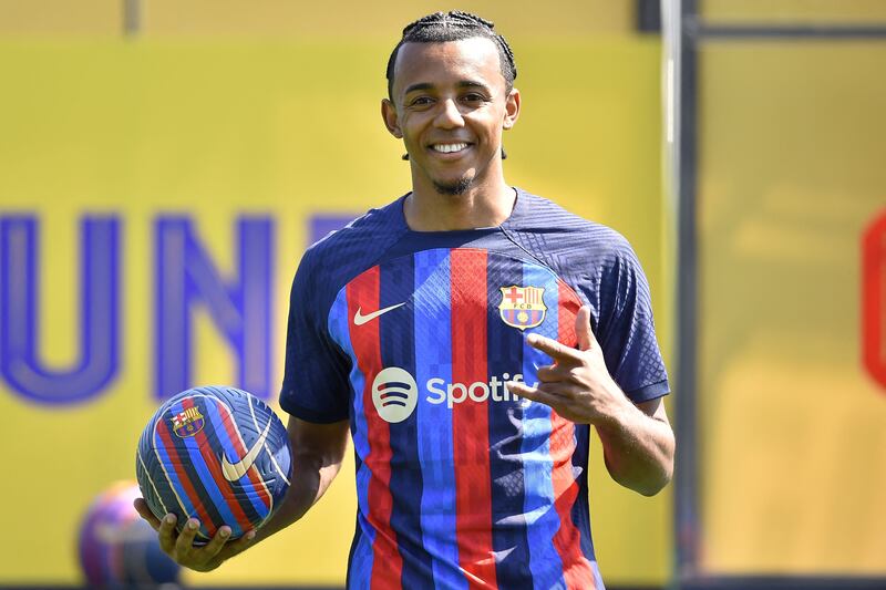 FC Barcelona's new french defender Jules Kounde poses for pictures during his presentation ceremony at the Joan Gamper training ground in Sant Joan Despi, near Barcelona, on August 1, 2022.  (Photo by Pau BARRENA  /  AFP)