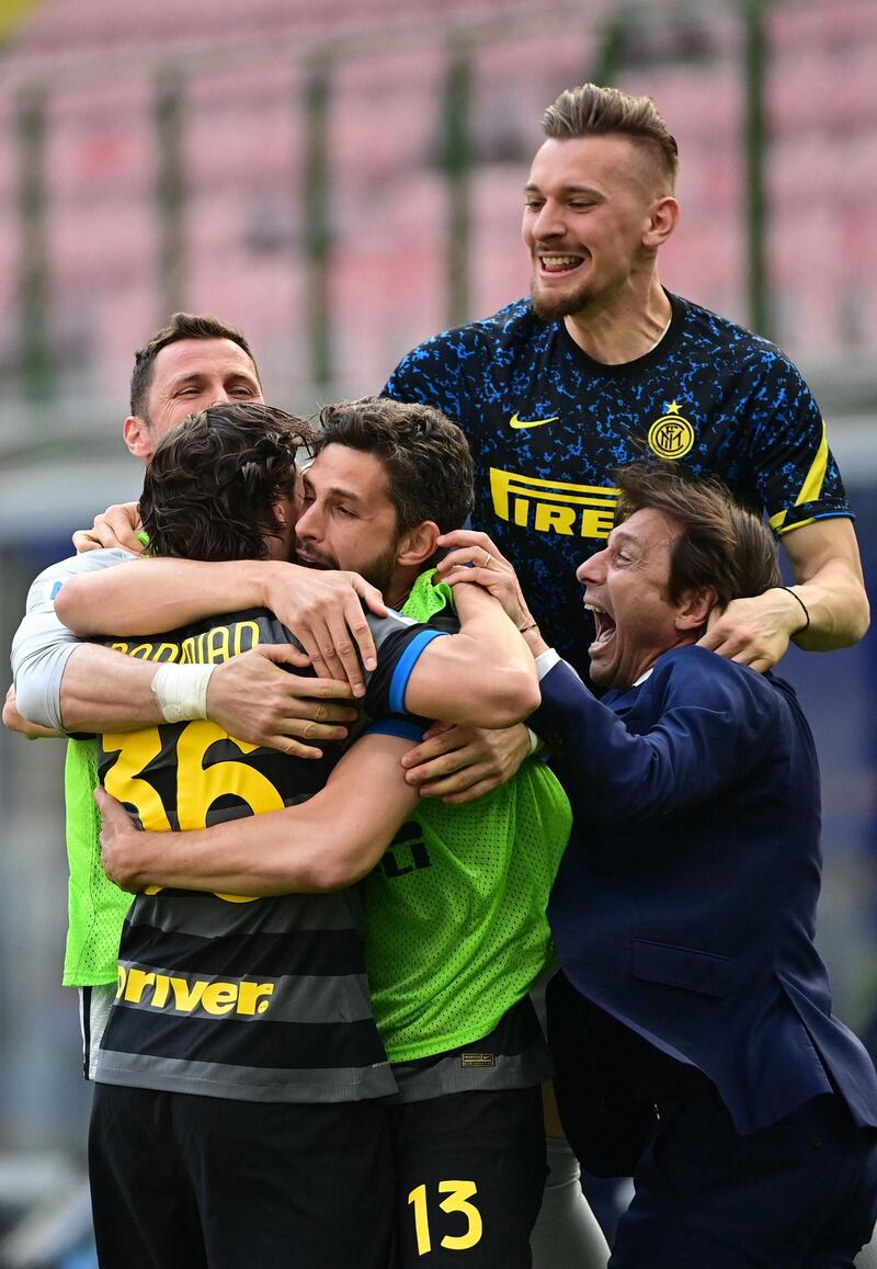 Inter Milan's Italian coach Antonio Conte and teammates celebrate at the final whistle. AFP