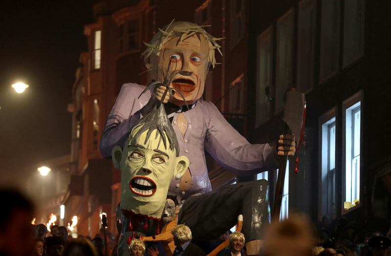 An effigy of Boris Johnson is paraded through the town. PA via AP