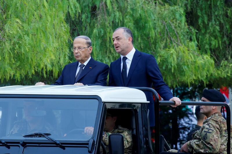 President Michel Aoun and caretaker Defense Minister Elias Bou Saab attend a military parade. Reuters