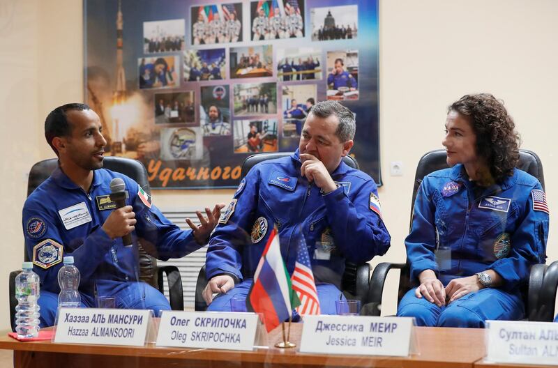 The trio answer questions in a mixture of languages - all must learn Russian for the mission - for the media. Shamil Zhumatov / Reuters