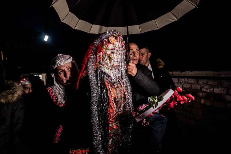 Eminkova walks along a street in her traditional make-up and costume. Getty
