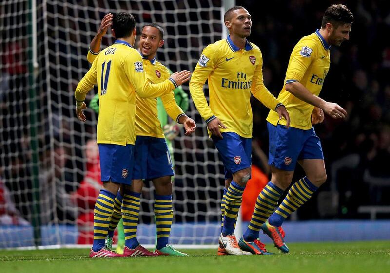 Arsenal players like Theo Walcott, second from left, and Mesut Oezil, left, could change the fortunes for their club in 2014 and finally hoist a trophy. Ian Walton/Getty Images