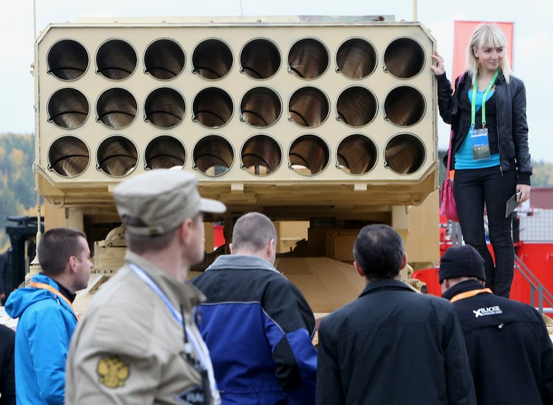 A woman poses on a Russian TOS-1 Buratino multiple rocket launcher during the Russia Arms Expo 2013. Reuters
