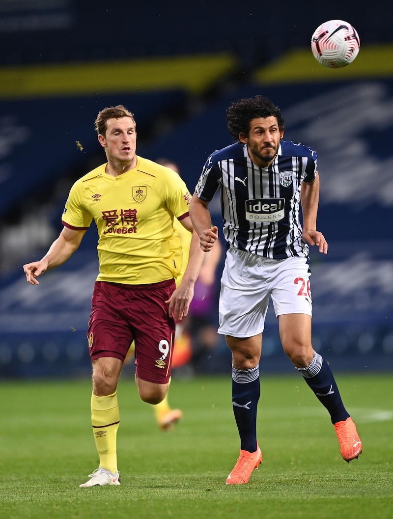 WEST BROMWICH, ENGLAND - OCTOBER 19: Ahmed Hegazi of West Bromwich Albion heads the ball under pressure from Chris Wood of Burnley during the Premier League match between West Bromwich Albion and Burnley at The Hawthorns on October 19, 2020 in West Bromwich, England. Sporting stadiums around the UK remain under strict restrictions due to the Coronavirus Pandemic as Government social distancing laws prohibit fans inside venues resulting in games being played behind closed doors. (Photo by Laurence Griffiths/Getty Images)