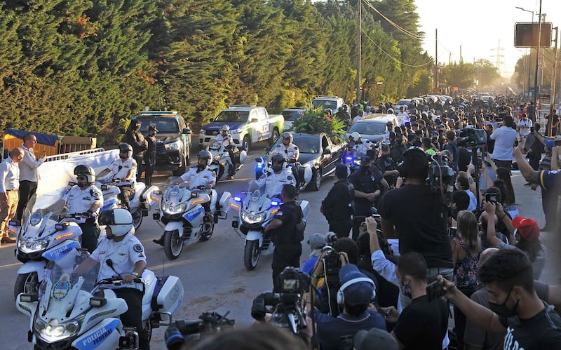 Fans follow the funeral procession carrying the remains of Diego Maradona. EPA
