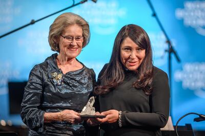 Saudi Arabian independent filmmaker Haifaa Al Mansour (R) receives a Crystal Award from the hands of Schwab Foundation for Social Entrepreneurship Chairperson and Co-Founder Hilde Schwab (L) during a ceremony ahead of the World Economic Forum (WEF) 2019 annual meeting, on January 21, 2019 in Davos, eastern Switzerland.   / AFP / Fabrice COFFRINI
