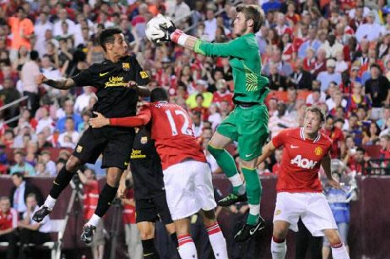 Manchester United's goalkeeper David De Gea, in green, in action against Barcelona.